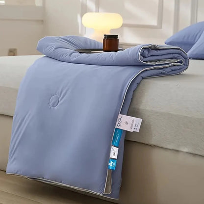 Double-side cooling blanket, lightweight and breathable, shown neatly folded, ideal for maintaining a cool and comfortable sleep